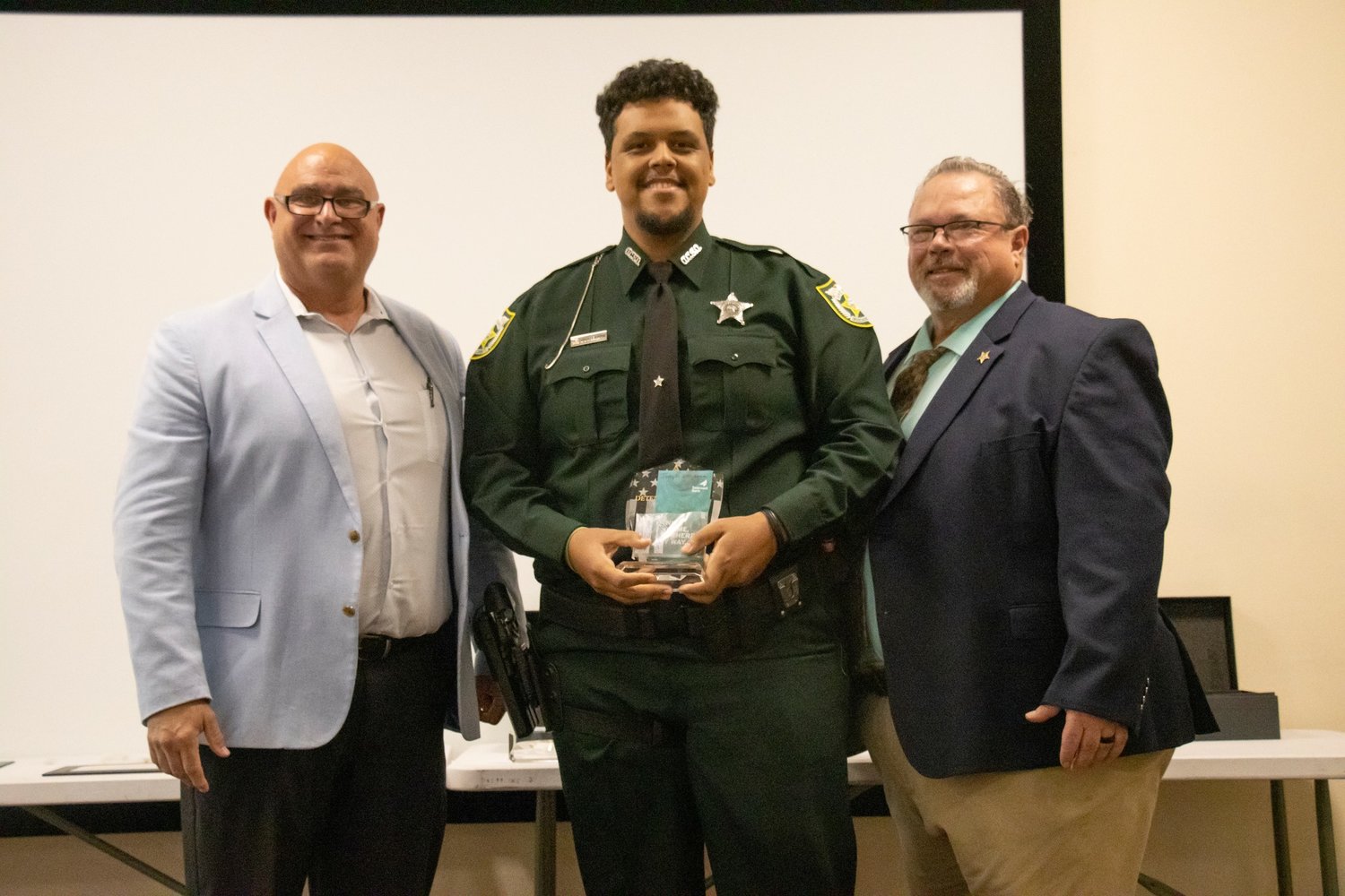 Today, we will tell you about Detention Deputy Joseph Benjamin, who was awarded our Detention Deputy of the Year Award.

Benjamin was nominated in the third quarter by one of his Command Staff members. Benjamin has an outstanding personality, is always willing to take on new tasks, always willing to learn, and to help out new Detention Deputies. Benjamin is very driven in his work, and gets along with everyone. He will be a great leader one day, and we look forward to seeing his continued success. Great Job Detention Deputy Benjamin, and Congratulations to you on your well deserved award.
Pictured left to right are Major Michael Hazellief, Deputy Benjamin and Sheriff Noel E. Stephen.